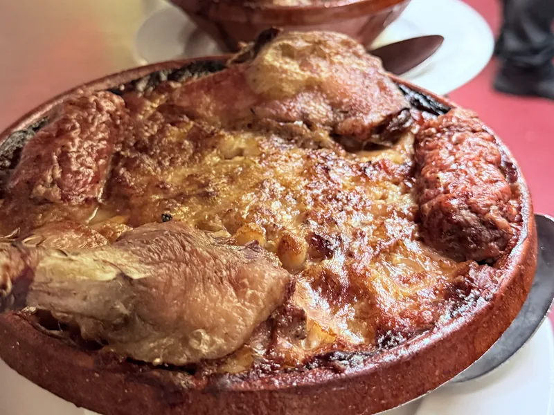 Duck confit baked in terracotta dishes — French bistro dinner at Paris Crêpes Café, Niagara Falls