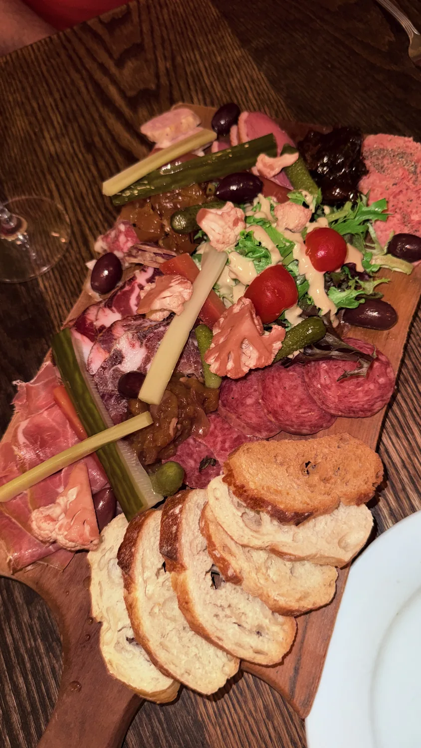 Assiette de charcuterie — saucisson, prosciutto, smoked duck breast and fresh baguette at Paris Crêpes Café