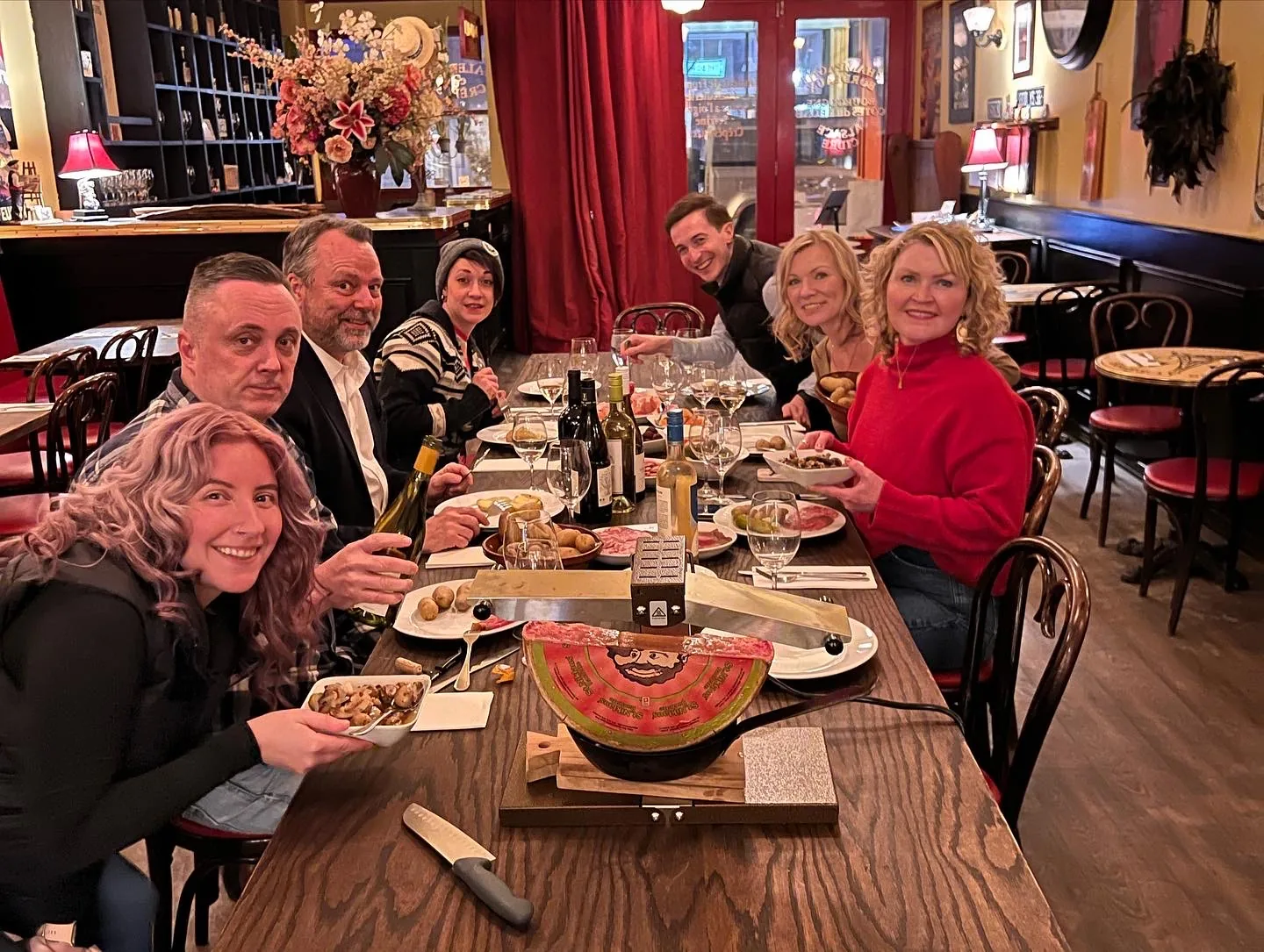 Guests sharing a raclette dinner in the dining room at Paris Crêpes Café, Niagara Falls
