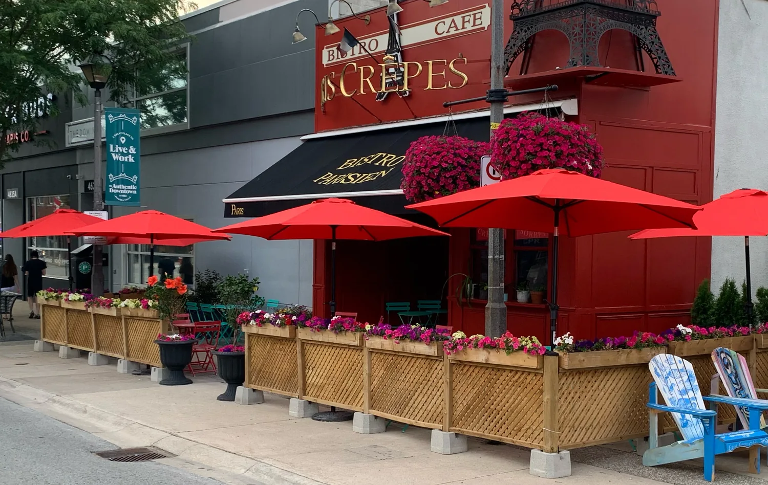 The red umbrella patio outside Paris Crêpes Café at 4613 Queen Street, Niagara Falls, Ontario